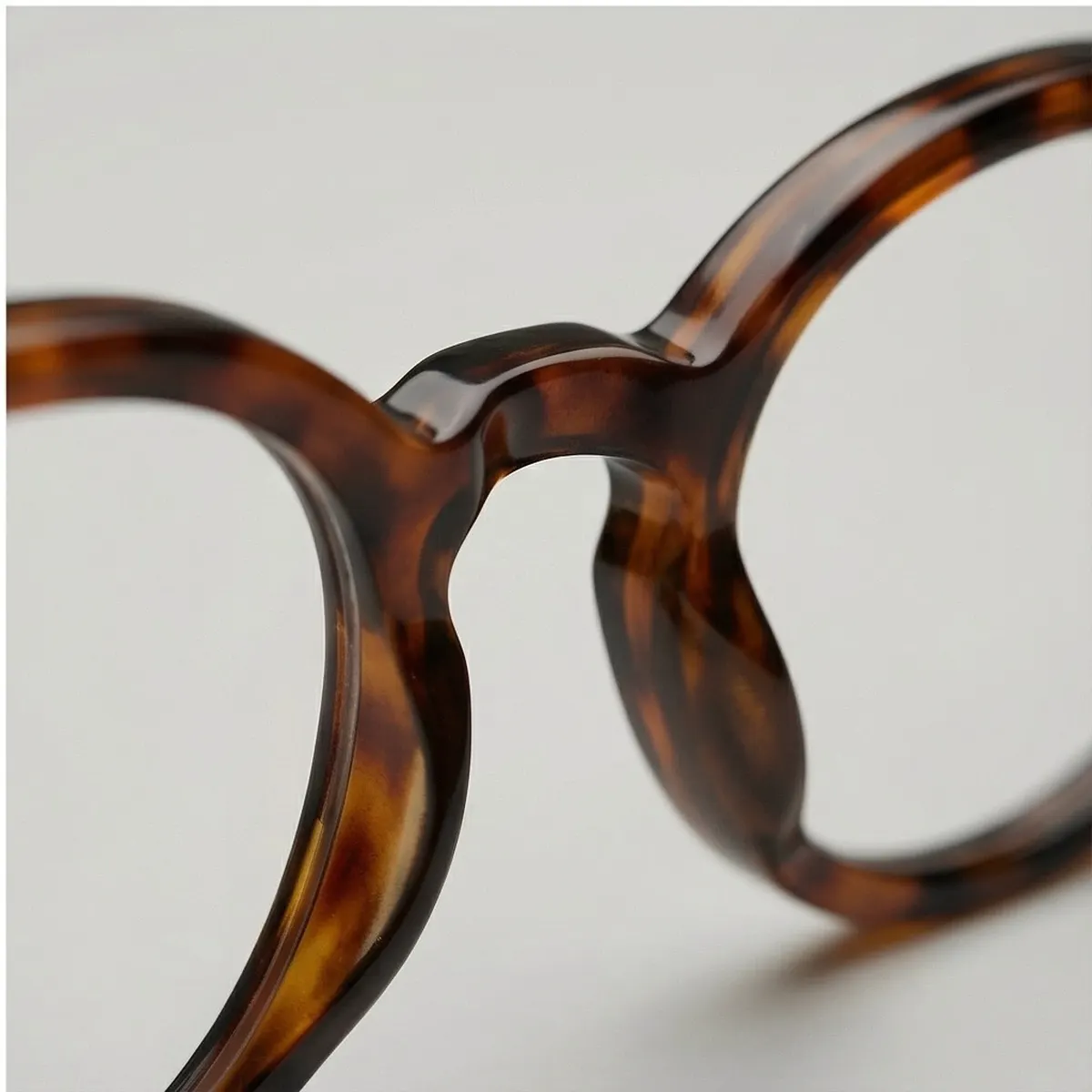 Close-up of the tortoiseshell glasses on a seamless grey studio background, made with Studio Zero Studio mode